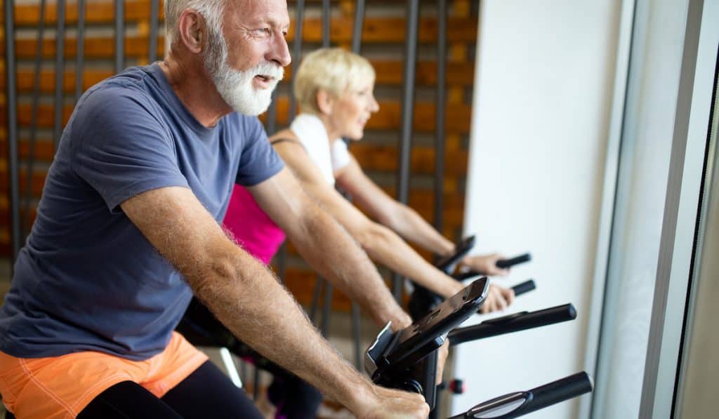 middle age couple exercising on the best exercise bike for seniors
