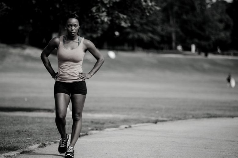 black woman in a park recovery from endurance activity