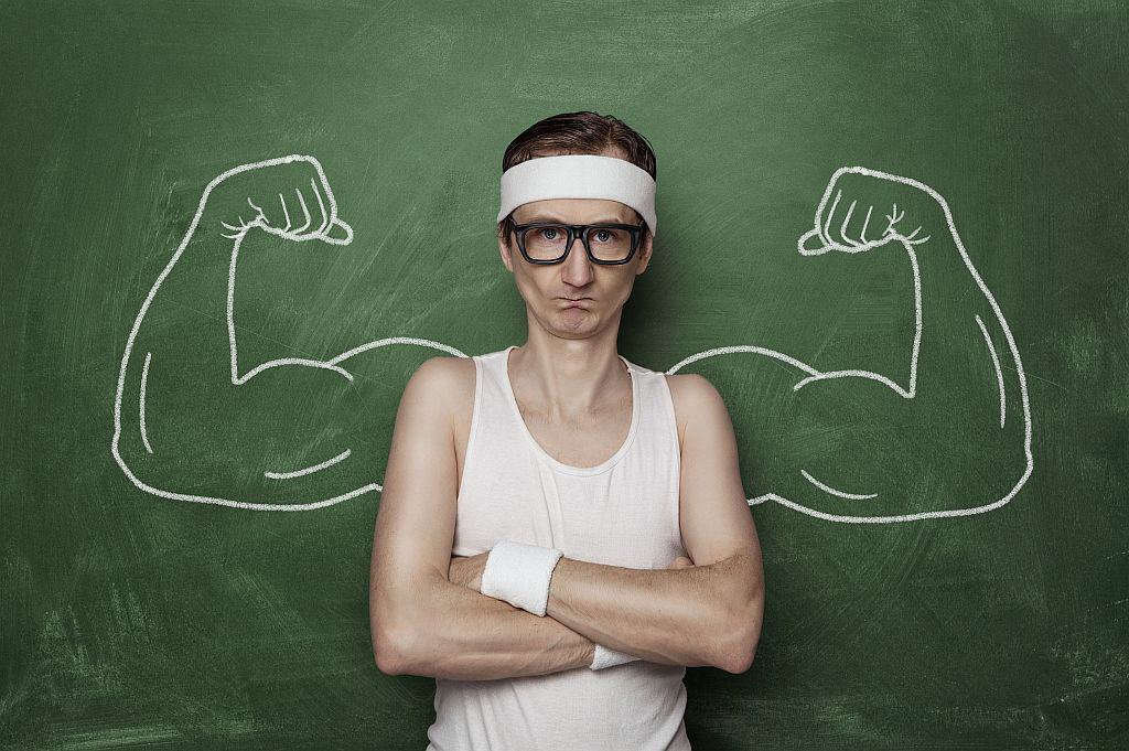 Funny sport nerd with fake muscle drawn on the chalkboard