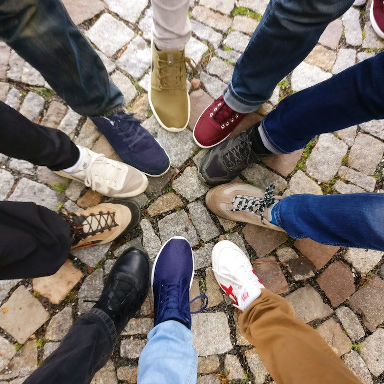 looking down on 10 different types of sneakers being worn cut off at the knee