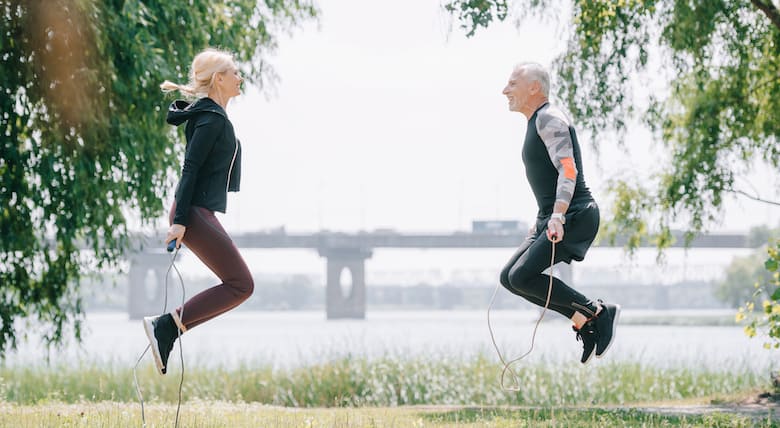 middle aged couple exercising in the park
