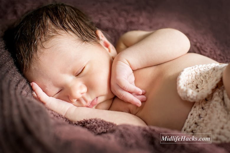 portrait cute newborn baby sleeping on brown blanket