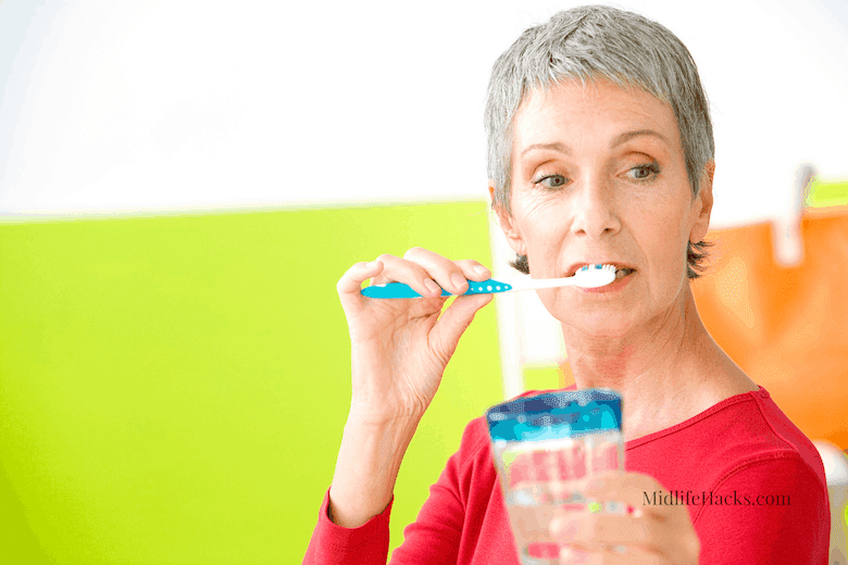 Middle aged lady brushing her teeth