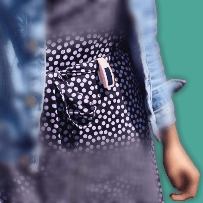 Woman with clip on fitness tracker on waist band