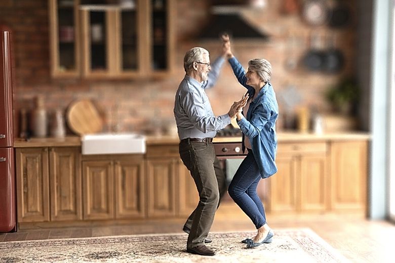 dancing couple in kitchen proving cardio after 50 needn’t be dull
