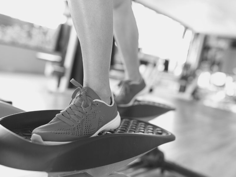 girl’s feet shown on an elliptical trainer
