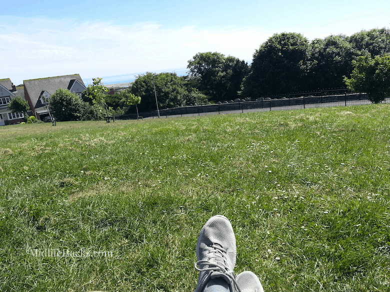 View from a hill with casual shoes being worn in the foreground
